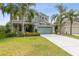 Inviting two-story home with a well-manicured lawn, lush landscaping, and a spacious two-car garage at 2842 Balforn Tower, Winter Garden, FL 34787