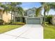 Inviting two-story home with a well-manicured lawn, lush landscaping, and a spacious two-car garage at 2842 Balforn Tower, Winter Garden, FL 34787
