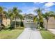 Charming two-story home with a well-manicured lawn, mature palm trees, and a two-car garage at 2842 Balforn Tower, Winter Garden, FL 34787