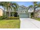 Charming two-story home boasts lush landscaping, a two-car garage, and a welcoming front entrance at 2842 Balforn Tower, Winter Garden, FL 34787