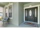 Charming front porch area with seating, a decorative welcome mat, and natural light from nearby windows at 2842 Balforn Tower, Winter Garden, FL 34787