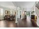 Open-concept space with hardwood floors, decorative columns, and views of the dining area and backyard at 2842 Balforn Tower, Winter Garden, FL 34787