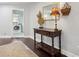Hallway features a wood table with decor, a large mirror, and a glimpse of the laundry room at 2842 Balforn Tower, Winter Garden, FL 34787