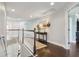 Bright upstairs hallway with hardwood floors, leading to various rooms and enhanced by stylish furnishings at 2842 Balforn Tower, Winter Garden, FL 34787