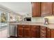 Modern kitchen with stainless steel appliances, wood cabinets, and outdoor views at 2842 Balforn Tower, Winter Garden, FL 34787