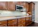 Well-lit kitchen featuring stainless steel appliances and wood cabinetry at 2842 Balforn Tower, Winter Garden, FL 34787