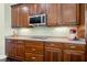 Elegant kitchen with stainless steel appliances, wood cabinets, and modern countertops at 2842 Balforn Tower, Winter Garden, FL 34787