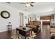 Cozy living room featuring hardwood floors and an open floor plan to the kitchen at 2842 Balforn Tower, Winter Garden, FL 34787