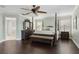 Large main bedroom with dark wood floors, four-poster bed, and elegant furnishings at 2842 Balforn Tower, Winter Garden, FL 34787