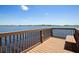 Wooden pier with bench seating along railing overlooking the open water and distant shoreline at 2842 Balforn Tower, Winter Garden, FL 34787