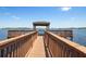 Scenic view of a wooden pier leading to a covered gazebo on a calm lake under a sunny sky at 2842 Balforn Tower, Winter Garden, FL 34787