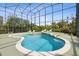 Beautiful kidney shaped pool with built-in spa surrounded by lounge chairs inside a screened enclosure at 2842 Balforn Tower, Winter Garden, FL 34787