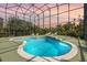 Relax in this screened pool area featuring a unique custom design and clear blue water at 2842 Balforn Tower, Winter Garden, FL 34787
