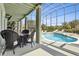 Relax in this screened pool area with a dining table and a unique custom design and clear blue water at 2842 Balforn Tower, Winter Garden, FL 34787