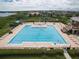 Aerial view of a large community swimming pool with lounge chairs and lush landscaping at 2842 Balforn Tower, Winter Garden, FL 34787