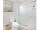 Bright bathroom featuring a toilet, glass enclosed shower, and window with natural light at 2927 Ahern Dr, Orlando, FL 32817