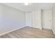 Bright bedroom with laminate flooring, closet, and a neutral paint scheme at 2927 Ahern Dr, Orlando, FL 32817