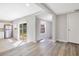 Bright living area featuring wood-look flooring and a sliding glass door to the backyard at 2927 Ahern Dr, Orlando, FL 32817