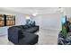 Spacious living room with modern gray sectional couch, light wood floors, and bright windows at 2927 Ahern Dr, Orlando, FL 32817