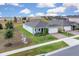 Wide aerial view of a single-story home with manicured lawn on a spacious lot in a residential neighborhood at 3017 Ambersweet Pl, Clermont, FL 34711