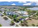 Aerial view of the community showcasing the clubhouse, pool, landscaping, and surrounding neighborhood at 3017 Ambersweet Pl, Clermont, FL 34711