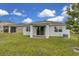 Backyard with a view of the patio, lawn, and neighboring houses at 3017 Ambersweet Pl, Clermont, FL 34711