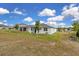 Backyard featuring a grassy lawn and a view of neighboring houses at 3017 Ambersweet Pl, Clermont, FL 34711
