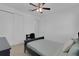 Cozy bedroom with a ceiling fan and a comfortable bed and dark furniture at 3017 Ambersweet Pl, Clermont, FL 34711