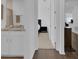 Bright hallway leading to a bedroom and bathroom with wood flooring at 3017 Ambersweet Pl, Clermont, FL 34711