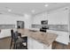 Bright kitchen features granite counters, stainless steel appliances, and a large island with seating at 3017 Ambersweet Pl, Clermont, FL 34711
