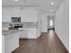 Bright kitchen with white cabinets, stainless steel appliances, hardwood floors and granite countertops at 3017 Ambersweet Pl, Clermont, FL 34711