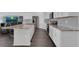 Open-concept kitchen featuring granite countertops, stainless steel appliances, and dark wood floors at 3017 Ambersweet Pl, Clermont, FL 34711