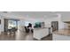 Open-concept living space with modern furnishings and a seamless flow to dining and kitchen areas at 3017 Ambersweet Pl, Clermont, FL 34711