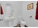 Powder room featuring modern fixtures, pedestal sink, and framed art at 3017 Ambersweet Pl, Clermont, FL 34711