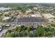 An aerial view showcases the property situated near shopping areas, businesses, and streets lined with lush, mature trees at 318 E Jersey St, Orlando, FL 32806