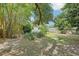 An exterior shot of a backyard with plants, grass and a wooden fence at 318 E Jersey St, Orlando, FL 32806