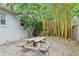 Backyard with a picnic table surrounded by plants and a wooden fence at 318 E Jersey St, Orlando, FL 32806