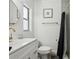This bright bathroom features a modern vanity, sleek gold fixtures, and shower with tiled walls at 318 E Jersey St, Orlando, FL 32806