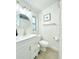 Clean and modern bathroom with a white vanity, updated fixtures, and a shower with a curtain at 318 E Jersey St, Orlando, FL 32806
