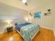Bedroom featuring hardwood floors, two large windows, and a bed with patterned bedspread at 318 E Jersey St, Orlando, FL 32806