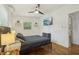Bright bedroom with hardwood floors, ceiling fan, and a wall-mounted television for optimal comfort at 318 E Jersey St, Orlando, FL 32806