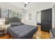 This bedroom offers natural light, hardwood floors, closet, and a calming decor at 318 E Jersey St, Orlando, FL 32806