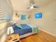 Comfortable bedroom with hardwood floors, a ceiling fan, and a serene color scheme at 318 E Jersey St, Orlando, FL 32806