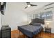 Bright bedroom with hardwood floors, ceiling fan, and an air conditioning unit for optimal comfort at 318 E Jersey St, Orlando, FL 32806