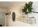 Elegant wall decor with decorative plates, a clock, and a potted plant on a modern metal shelf at 318 E Jersey St, Orlando, FL 32806