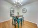 Bright dining area featuring hardwood floors, modern lighting fixture, and an accent wall decor at 318 E Jersey St, Orlando, FL 32806