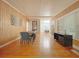 Open-concept dining room boasts wood-paneled walls, hardwood floors, and stylish contemporary furnishings at 318 E Jersey St, Orlando, FL 32806