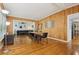 Spacious open-concept dining and living area with wood paneling and hardwood floors throughout at 318 E Jersey St, Orlando, FL 32806