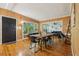 Well-lit dining room featuring a wooden table set, hardwood floors, and access to the living room at 318 E Jersey St, Orlando, FL 32806