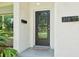 A close-up of the home's front entry, complete with a sleek door and modern address plate at 318 E Jersey St, Orlando, FL 32806